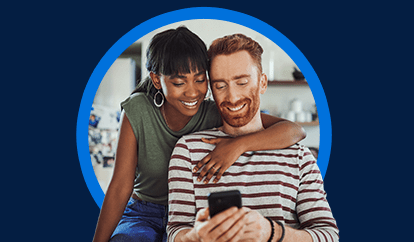 couple in kitchen looking at phone together