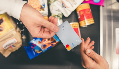 Woman on phone looking at cash back rewards with groceries